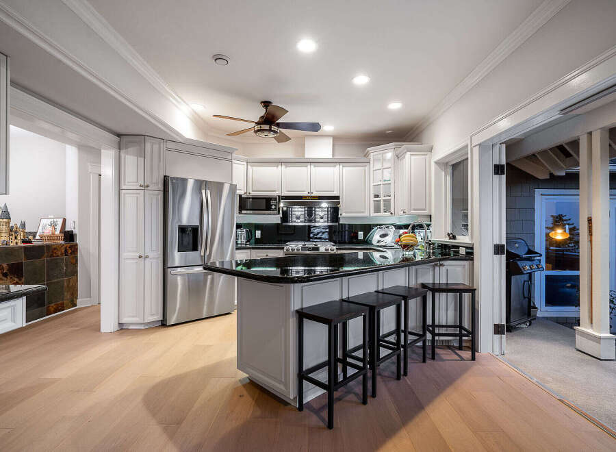 This stunning kitchen boasts a modern design with sleek stainless steel appliances and a spacious island perfect for entertaining.