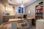 This home office offers a stylish and functional workspace with a modern desk and ample natural light.