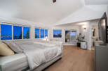 Experience luxury living in this stunning bedroom with breathtaking views.