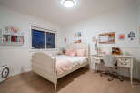 This charming bedroom offers a cozy and inviting atmosphere, perfect for relaxation.