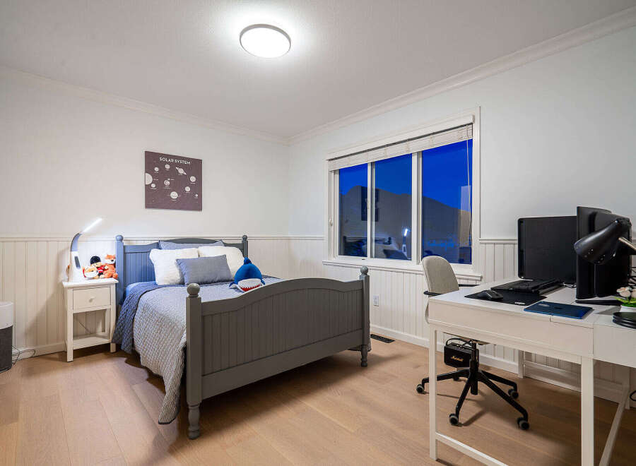 This inviting bedroom offers a blend of comfort and functionality, perfect for relaxation and productivity.