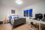 This inviting bedroom offers a blend of comfort and functionality, perfect for relaxation and productivity.