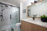 Step into a beautifully designed bathroom featuring a modern glass shower enclosure and sleek black fixtures.