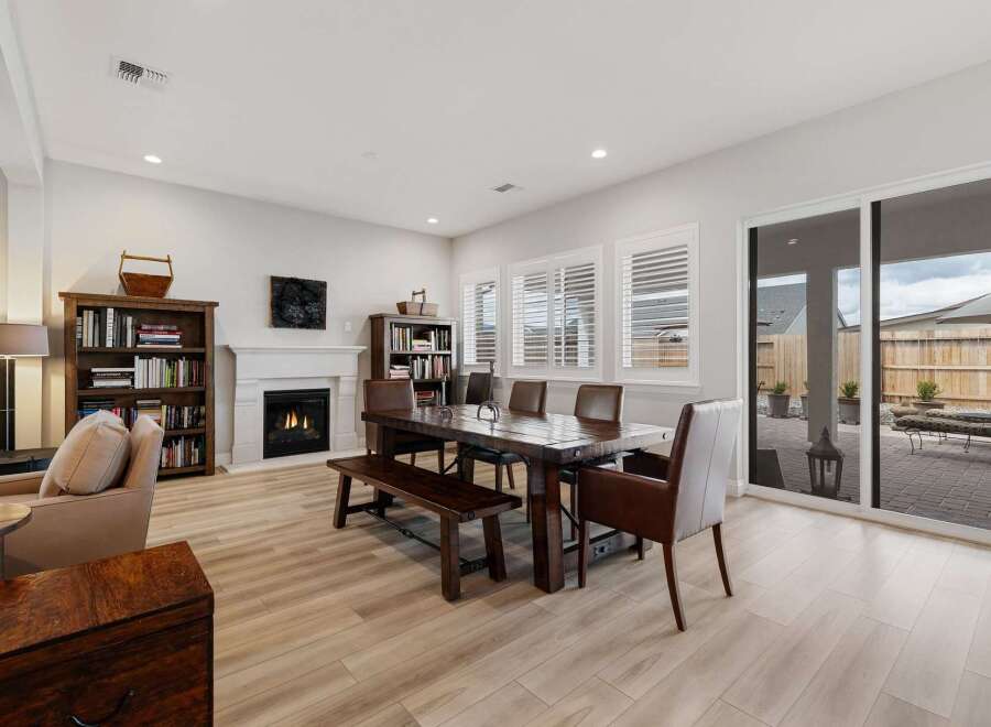 This stunning property boasts a spacious living area with a cozy fireplace, perfect for relaxing evenings.