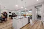 This stunning kitchen boasts a modern design with a spacious island, perfect for meal preparation and entertaining.