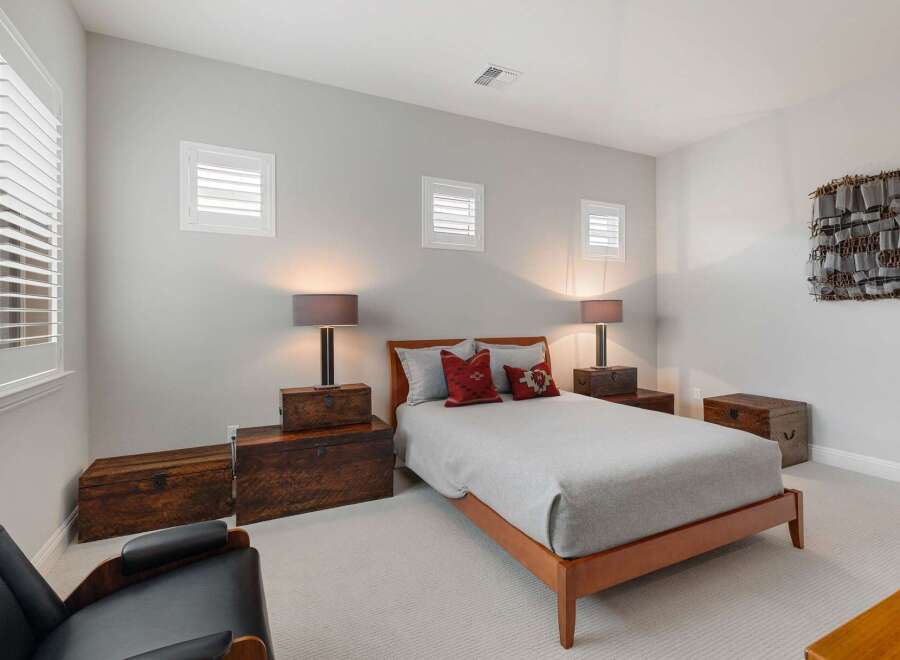 Discover the charm of this inviting bedroom, featuring a cozy bed and stylish decor.