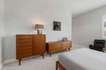 This stunning bedroom boasts a mid-century modern aesthetic, perfect for those seeking a stylish and functional space.