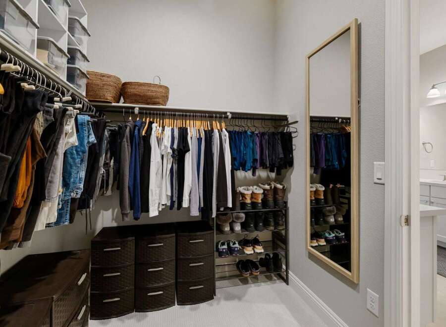 Step into luxury with this meticulously designed walk-in closet, offering ample storage and organization.