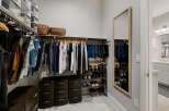 Step into luxury with this meticulously designed walk-in closet, offering ample storage and organization.