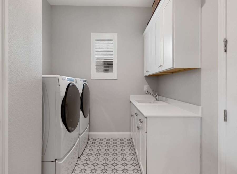 This stunning laundry room boasts modern design and functionality.