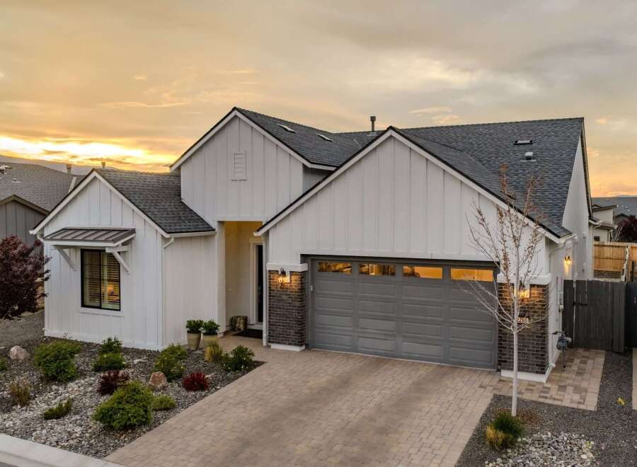 This stunning property boasts a modern farmhouse design with a welcoming facade.