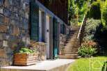 Discover the charm of this stunning property, featuring a beautiful stone facade and inviting green shutters.