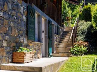 Discover the charm of this stunning property, featuring a beautiful stone facade and inviting green shutters.