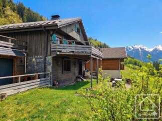 Discover a charming wooden chalet nestled in a picturesque mountain setting.