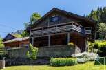 Discover this charming wooden chalet nestled in a picturesque mountain setting.