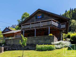 Discover this charming wooden chalet nestled in a picturesque mountain setting.