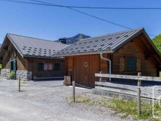 Discover a charming wooden chalet nestled in a picturesque mountain setting.