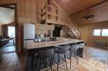 This stunning property boasts a beautifully designed kitchen with a modern island and stylish bar stools, perfect for entertaining.