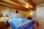 This cozy bedroom features a rustic wooden interior, creating a warm and inviting atmosphere.