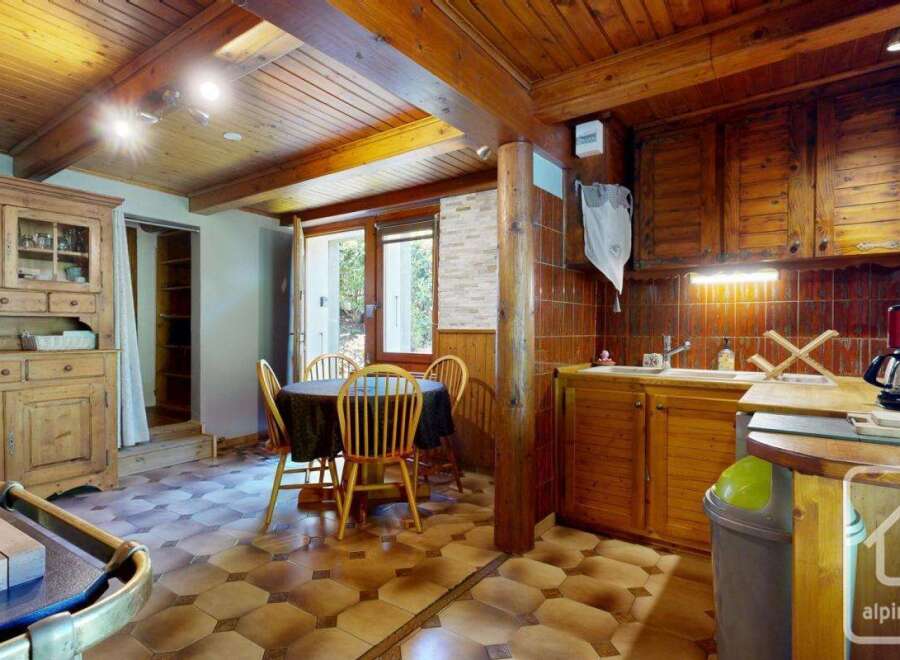 Discover the charm of this rustic kitchen, featuring warm wooden cabinetry and a cozy dining area.