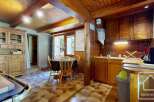Discover the charm of this rustic kitchen, featuring warm wooden cabinetry and a cozy dining area.
