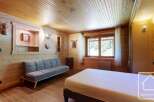 Discover the charm of this cozy mountain retreat, featuring a warm wooden interior and a comfortable living space.