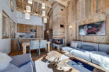 Experience luxury living in this stunning chalet, featuring a cozy fireplace and a modern kitchen.