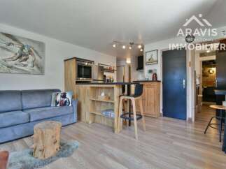 Discover this charming property featuring a cozy living space with a comfortable sofa and a unique wooden stump table.