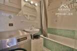 Discover this charming bathroom featuring a convenient washing machine, a stylish sink, and a relaxing bathtub.