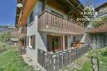 Discover this charming property featuring a traditional wooden balcony and facade, perfect for enjoying the scenic mountain views.