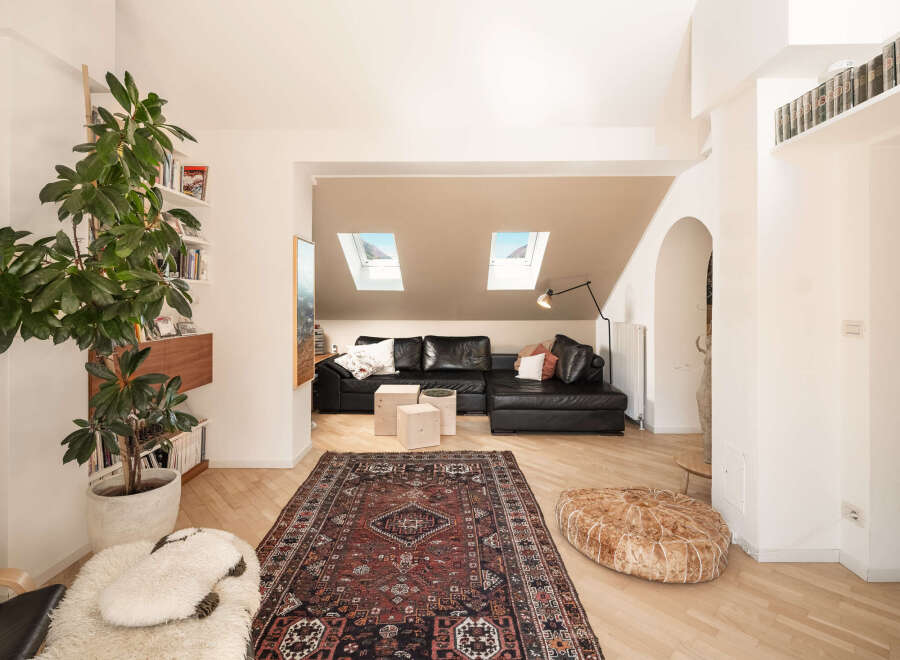 This stunning property boasts a modern living space with a stylish black leather sectional sofa, perfect for relaxation.