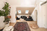 This stunning property boasts a modern living space with a stylish black leather sectional sofa, perfect for relaxation.