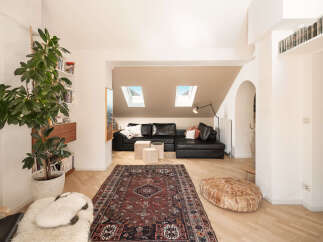 This stunning property boasts a modern living space with a stylish black leather sectional sofa, perfect for relaxation.