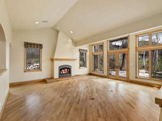 This stunning living room boasts a cozy fireplace, perfect for chilly evenings.
