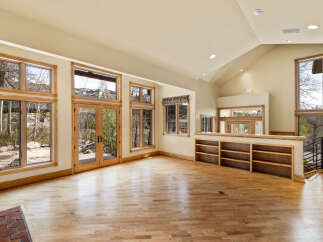 This stunning property boasts a spacious living area with abundant natural light streaming through large windows.