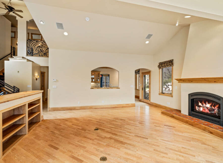 This stunning property boasts a spacious living area with a cozy fireplace, perfect for relaxing evenings.