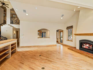 This stunning property boasts a spacious living area with a cozy fireplace, perfect for relaxing evenings.