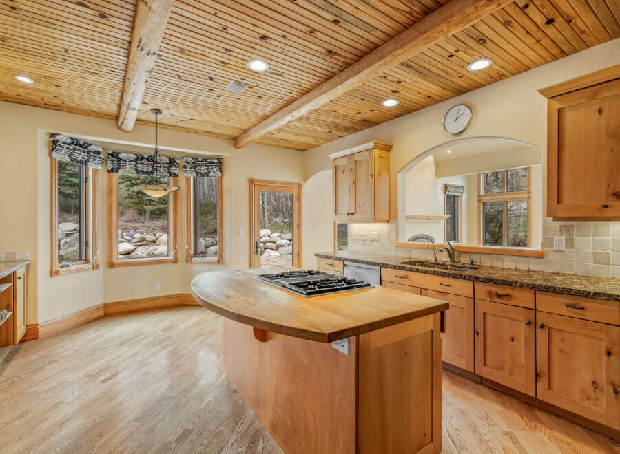 This stunning kitchen boasts a warm and inviting atmosphere with its natural wood cabinets and flooring.