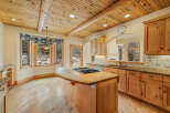This stunning kitchen boasts a warm and inviting atmosphere with its natural wood cabinets and flooring.