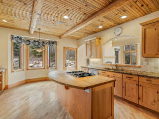 This stunning kitchen boasts a warm and inviting atmosphere with its natural wood cabinets and flooring.