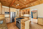 This stunning kitchen boasts a warm and inviting atmosphere, perfect for culinary enthusiasts.