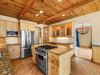 This stunning kitchen boasts a warm and inviting atmosphere, perfect for culinary enthusiasts.