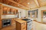 This stunning kitchen boasts a warm and inviting atmosphere with its wooden ceiling and cabinetry.