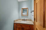 This stunning bathroom boasts a beautiful vanity with a granite countertop, offering both style and functionality.