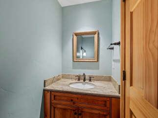 This stunning bathroom boasts a beautiful vanity with a granite countertop, offering both style and functionality.