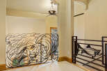 This stunning property boasts a unique wrought iron railing with a wolf design, adding a touch of artistry to the interior.