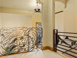 This stunning property boasts a unique wrought iron railing with a wolf design, adding a touch of artistry to the interior.