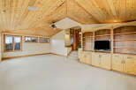 This stunning property boasts a spacious interior with a unique wooden ceiling, creating a warm and inviting atmosphere.