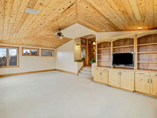 This stunning property boasts a spacious interior with a unique wooden ceiling, creating a warm and inviting atmosphere.