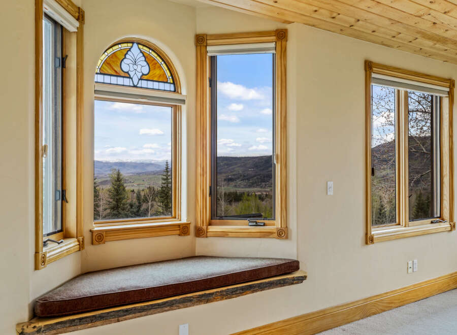 This stunning property boasts a unique architectural design with expansive windows that frame breathtaking mountain views.